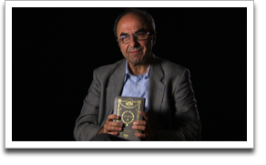 Rexhep Hoxha from his interview, holding one of the Hebrew prayerbooks left behind by the Jewish family his Muslim father rescued. ©JWM Productions, LLC