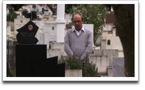 Rexhep Hoxha at the grave of his father, Rifat, who rescued a Jewish family in WWII. ©JWM Productions, LLC